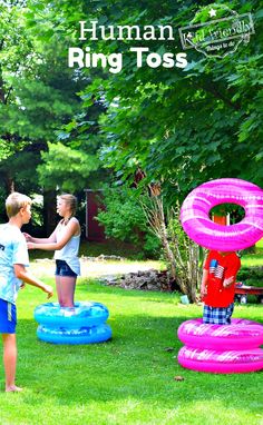 two children playing in an inflatable ring toss game