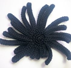 a black piece of yarn that looks like a flower