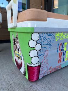 an ice chest painted to look like it has been decorated with images and words on the side