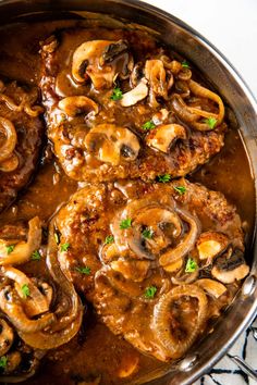 meat with mushrooms and gravy in a skillet