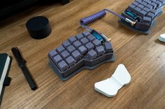 two pieces of plastic sitting on top of a wooden table next to a keyboard and mouse