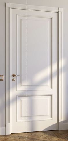 an empty room with a white door and wooden floor