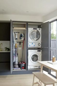 a washer and dryer are in the closet next to each other on the floor