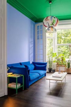 a living room with blue and green walls