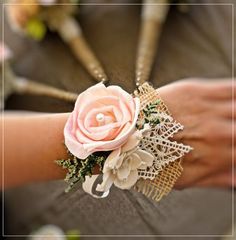 a close up of a person's arm with a flower and lace on it