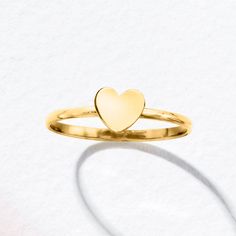 Ross-Simons - 10kt Yellow Gold Heart Ring Size 5. Canaria fine jewelry. Perfect for everyday wear, these genuine 10kt gold wardrobe essentials are fashionable, fun and designed to last a lifetime. Strong and durable, our collection of gold classics is always a great value. This handcrafted 10kt yellow gold ring presents a simple glossy heart. Wear it solo or stacked to keep love at the center of your style. 1/4" wide. 10kt yellow gold heart ring. Everyday Yellow Gold Heart Ring With Charm, Gold Stackable Heart Ring For Valentine's Day, Everyday Yellow Gold Heart Charm Ring, Classic Everyday Heart Ring For Valentine's Day, Gold Heart Ring With Charm For Everyday, Sterling Silver Yellow Gold Heart Ring, Stackable, Stackable Yellow Gold Heart Ring In Sterling Silver, Yellow Gold Sterling Silver Stackable Heart Ring, Everyday Gold Heart Ring With Heart Charm