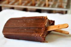 a chocolate popsicle sitting on top of a white napkin