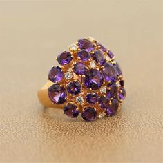 For Sale on 1stdibs - A marvelous domed cocktail ring featuring 15.94 carats of vivid purple amethyst. The round cut gems are clustered with 0.63 carats of VS quality diamonds Royal Purple Color, Cluster Ring Set, Amethyst Cocktail Ring, Pink Gold Rings, Gold Cocktail, Coral Ring, Gold Cocktail Ring, Twisted Band, Colorless Diamond