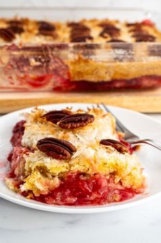 a piece of pie on a plate with a fork next to it and a casserole dish in the background