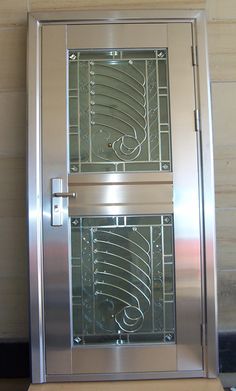 two stainless steel double doors with intricate designs