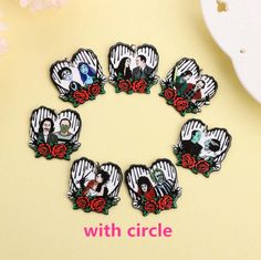 there are six pictures of people in the shape of hearts on this brooch pin