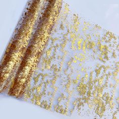 gold and white paper with glitter on it