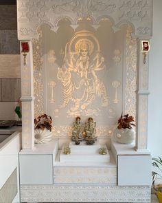 there is a statue on top of the white shelf in front of the buddha wall