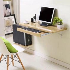 a computer desk with a monitor, keyboard and mouse on it next to a chair