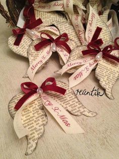 some old book pages are decorated with red ribbon and bowknots for christmas