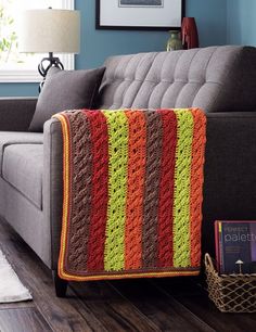 a living room with a couch and a blanket on the floor