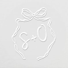 a white paper cutout with the word q and o written in cursive writing