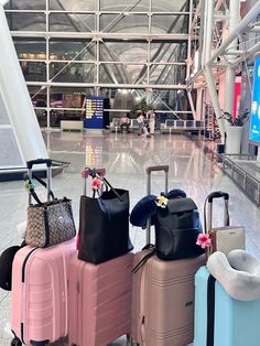 four suitcases are lined up in an airport