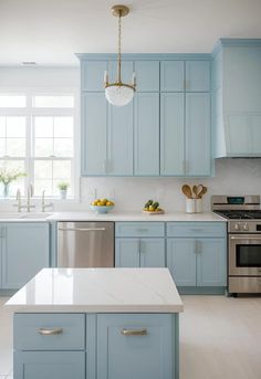 a kitchen with blue cabinets and white counter tops