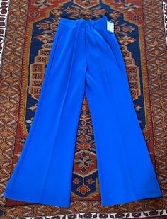 Vintage 1970's blue poly/acrylic pull on pants with elastic waist made by Upstairs Closet.  28" waist unstretched, 29" inseam, 40" length Unworn deadstock with original tags, great condition! Blue Wide-leg Pull-on Pants, Blue Fitted Pants With Elastic Waistband, Fitted Blue Pants With Elastic Waistband, Retro Stretch Blue Pants, Retro Blue Stretch Pants, Blue Retro Stretch Pants, Blue Retro Pants For Spring, Blue Full-length Pull-on Pants, Fitted Blue Pull-on Pants