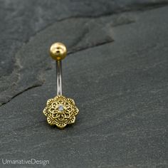 Tribal, Beautiful Flower Mandala Belly Button Ring Decorated With Zircon Gemstone. Material : 316L Surgical Steel Pin, Top ball and the bottom disc is made of Brass Top ball's diameter is: 0.19 Inch - 5mm Bottom disc's diameter is: 0.33 Inch - 8.6mm Pin is : 14g - 1.6mm thick and 0.47 Inch - 11.5mm long *Nickel Free You can find more belly piercing at this link- https://www.etsy.com/shop/Umanativedesign?section_id=16522336&ref=shopsection_leftnav_5 All of our Umanative Design jewelry are han Adjustable Gold Belly Rings For Wedding, Piercing Navel, Rings Flower, Belly Piercing Jewelry, Belly Bars, Ring Flower, Navel Ring, Button Rings, Belly Piercing