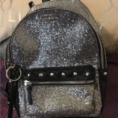 Shop chevyg20's closet or find the perfect look from millions of stylists. Fast shipping and buyer protection. Absolutely beautiful Victory Secret Black & Silver Bling Backpack! Used Once! Still Looks Brand New! In Pristine Condition! Silver Toned Hardware, Gorgeous Solid Black on The Back, Inside Is in Pristine Condition. So Cute. I Am REPOSTING! USED ONCE ! STILL IN PRISTINE CONDITION! Asking Less THEN WHAT I PAID AS Used Once! No Offers Please! So NICE! Bundle & Save a- Lot More.ty Silver Backpack With Zipper Closure, Travel Backpack With Zipper Closure In Silver, Silver School Bag With Zipper Closure, Silver Standard Backpack For School, Victory Secret, Victoria Secret Black, Silver Bling, Victoria Secrets, Handbag Wallet