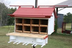 a white and red building with bee boxes in it