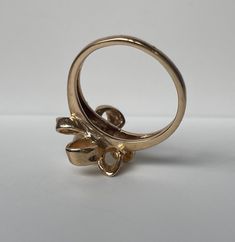 This is a fun floral pearl ring crafted in the Mid-Century era. The ribbon like petals form a large floral bow with has great finger coverage. This is a sweet feminine look. 14K Yellow Gold Weight: 4.59g size 6 (sizable upon request) People have coveted natural pearls as symbols of wealth and status for thousands of years. A Chinese historian recorded the oldest written mention of natural pearls in 2206 BC. As the centuries progressed toward modern times, desire for natural pearls remained stron Unique Yellow Gold Pearl Ring For Wedding, Vintage Flower Ring For Formal Occasion, Vintage Flower Rings For Formal Occasions, Yellow Gold Pearl Ring For Anniversary, Unique 14k Gold Pearl Wedding Ring, Unique 14k Gold Pearl Ring For Wedding, Formal Vintage Flower Ring, Heirloom Flower Rings For Formal Occasions, Formal Heirloom Flower Rings