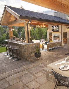 an outdoor kitchen and dining area is shown