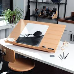 an easel sitting on top of a white desk