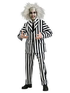 a man in a striped suit with white hair and clown makeup is posing for the camera