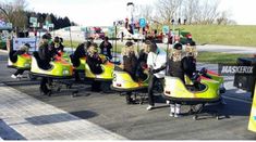 several people are riding bumper cars on the street