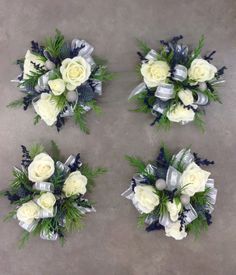 three bouquets of white roses and greenery on the cement floor next to each other