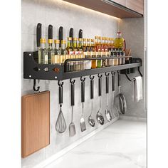 a rack with utensils hanging from it's side in front of a counter