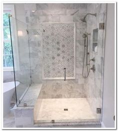 a bathroom with a walk in shower next to a bath tub