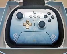 a close up of a nintendo wii game controller in a box with its lid open