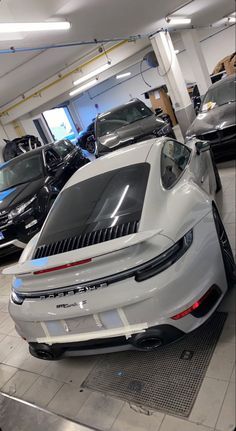 a white sports car parked in a showroom