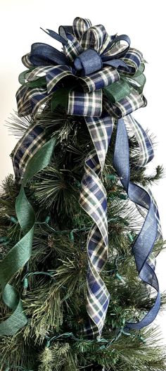 a christmas tree decorated with blue and green ribbons