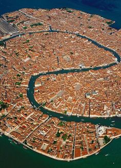 an aerial view of a city and its surrounding waterway in the middle of the ocean