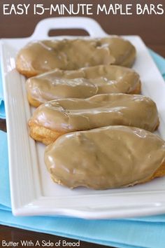 three glazed donuts on a white plate