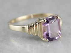 Outstanding! This modern yellow gold setting perfectly frames the amethyst we've set at the center! The tapering stepped yellow gold band looks soft and elegant on the finger, while the rich purple gem glitters with violet sparkles! Metal: 14K Yellow Gold Gem: Amethyst 2.85 Carats Gem Measurements: 7.8 x 9.9 mm, Emerald Cut Ring Size: 10 Marks: "14K UP" Stamped on the inside band 10 Marks, Purple Gems, Emerald Cut Rings, Rich Purple, Vibrant Purple, Yellow Gold Setting, Gold Set, Ring Ring, Gold Band