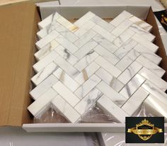 a box with some white marble tiles in it