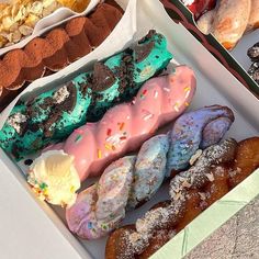 an assortment of doughnuts and pastries in boxes