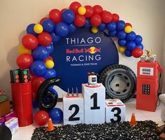 a table topped with blocks and balloons in front of a sign that says chicago red bull racing