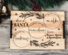 personalized cutting board with christmas sayings on it and pine branches in the background