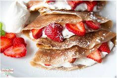 crepes topped with strawberries and whipped cream