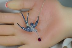 "STORE RETAIL $6,700 VERY FEMININE & ELEGANT SWALLOW BIRD NECKLACE & BROOCH. Meet Dalia, & she is incredibly gorgeous in person...beautiful clean sparkling diamond body & bright blue sapphire wings & elegant split sapphire tail. She is carrying a large oval solitaire ruby on an 18k chain & she has a matching BRIGHT ruby eye. Dalia is a larger necklace, yet very elegant. She has a unique chain which IS included that is 2 separate chains that hook on special concealed loops Swallow Bird, Large Necklace, Animal Nature, Bird Necklace, Bird Pendant, Blue Sapphire Diamond, Sparkling Diamond, Sapphire Diamond, Sparkle Diamonds