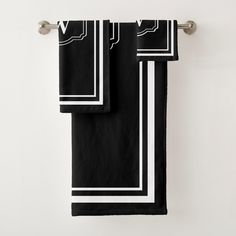 black and white towels hanging on a towel rack