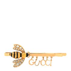 This is an authentic GUCCI Crystal Resin Logo Bee Hair Barrette in Gold and Black. This stylish hair barrette is crafted of a crystalized bee and with dangling letters spelling out 'GUCCI'. Resin Logo, Logo Bee, Crystal Resin, Stylish Hair, Hair Barrettes, Gold Black, Bee, Gucci, ? Logo