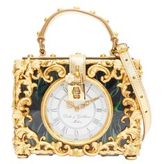 rare DOLCE GABBANA Box Orologio Barocco gold metal green marble resin vanity bag Reference: TGAS/D01025 Brand: Dolce Gabbana Designer: Domenico Dolce and Stefano Gabbana Model: Box Orologio Barocco Material: Acetate, Metal, Leather Color: Green, Gold Pattern: Barocco Closure: Turnlock Lining: Green Leather Extra Details: Dolce & Gabbana‚Äôs refined and exquisite flair for design is exquisitely demonstrated here. A spectacular piece brimming with baroque motifs and luxurious ornaments, this multicoloured Box Orologio Barocco bag from Dolce & Gabbana is a sure-fire way to not only revamp your outfit but also make the boldest of statements. It features a square body, a top handle, a detachable and adjustable shoulder strap, purse feet, a main internal compartment, an internal slip pocket, an Bijoux Fil Aluminium, Vanity Bag, Unique Purses, Stefano Gabbana, Designer Crossbody Bags, Cute Bags, Dolce & Gabbana, Green Leather, Bago